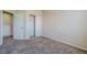 A carpeted bedroom with a closet and convenient access to the hall at 5282 Monterey Park Cir, Las Vegas, NV 89146