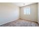 A carpeted bedroom featuring a bright window and neutral walls at 5282 Monterey Park Cir, Las Vegas, NV 89146