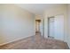 A carpeted bedroom with a closet and easy access to the hall at 5282 Monterey Park Cir, Las Vegas, NV 89146