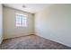 Carpeted bedroom with a large window for natural light and homey feel at 5282 Monterey Park Cir, Las Vegas, NV 89146