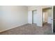 A spacious carpeted bedroom with a closet and easy access to the hall at 5282 Monterey Park Cir, Las Vegas, NV 89146