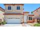 Charming two-story home with a white garage door and a red tile roof in a suburban neighborhood at 5282 Monterey Park Cir, Las Vegas, NV 89146