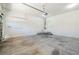 Spacious two-car garage featuring a white door and ample room for parking and storage at 5282 Monterey Park Cir, Las Vegas, NV 89146