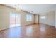 Spacious living room with wood floors and a sliding glass door to the backyard at 5282 Monterey Park Cir, Las Vegas, NV 89146