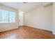 Bright living room with wood flooring, a white front door, and a large window at 5282 Monterey Park Cir, Las Vegas, NV 89146