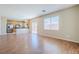 Open-concept living room and kitchen area with wood floors and stainless steel appliances at 5282 Monterey Park Cir, Las Vegas, NV 89146