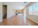 Bright and airy living room with kitchen view, wood floors, and a staircase at 5282 Monterey Park Cir, Las Vegas, NV 89146
