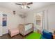 A bright bedroom featuring a crib and a twin bed at 531 New Mexico St, Boulder City, NV 89005