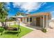 Charming single-story home showcasing a well-maintained yard and inviting front porch with swing at 531 New Mexico St, Boulder City, NV 89005