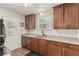 Updated kitchen with stainless steel sink, wood cabinets, and bright countertops at 531 New Mexico St, Boulder City, NV 89005