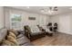 Comfortable living room featuring wood floors, bright windows, and a cozy seating area at 531 New Mexico St, Boulder City, NV 89005