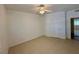 Clean, minimalist bedroom with tile floors, neutral walls, ceiling fan, and a mirrored closet at 5751 E Hacienda Ave # 226, Las Vegas, NV 89122