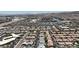 Wide aerial shot displays a Primary-planned community featuring neatly arranged residences, commercial buildings, and transportation routes at 5927 Villa Loma St, Las Vegas, NV 89148