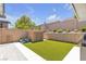 A backyard features artificial turf, a block wall, and lush greenery at 5927 Villa Loma St, Las Vegas, NV 89148
