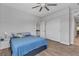 Bright bedroom featuring modern flooring, a large closet, and a comfortable bed with a blue coverlet at 5927 Villa Loma St, Las Vegas, NV 89148