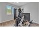 Bright bedroom featuring exercise equipment and a window with blinds at 5927 Villa Loma St, Las Vegas, NV 89148