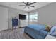 Bright bedroom with a ceiling fan, a window and a dresser with a TV on top of it at 5927 Villa Loma St, Las Vegas, NV 89148