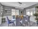 Bright dining room featuring modern chandelier, wainscoting, and views to the landscaped yard at 5927 Villa Loma St, Las Vegas, NV 89148