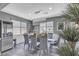 Dining room featuring a modern chandelier, floating shelves, and adjacent access to the wine cellar at 5927 Villa Loma St, Las Vegas, NV 89148