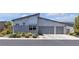 Modern home showcasing a two-car garage and professionally landscaped front yard at 5927 Villa Loma St, Las Vegas, NV 89148