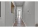 Well-lit hallway with neutral paint and wood-look floors, providing seamless flow through the home at 5927 Villa Loma St, Las Vegas, NV 89148