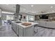 Open-concept kitchen with large island, stainless steel hood, and views of the dining and living area at 5927 Villa Loma St, Las Vegas, NV 89148