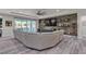 Spacious living room with stone accent wall, large sectional sofa, and sliding glass doors to the backyard at 5927 Villa Loma St, Las Vegas, NV 89148