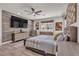 Stunning primary bedroom with luxury decor, a ceiling fan, and a mounted TV at 5927 Villa Loma St, Las Vegas, NV 89148
