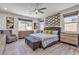 Spacious primary bedroom with modern decor, including a textured accent wall and sleek furniture at 5927 Villa Loma St, Las Vegas, NV 89148
