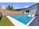 Backyard pool features lounge chairs and lush landscaping in a private setting at 5927 Villa Loma St, Las Vegas, NV 89148
