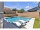 Backyard pool with lounge chairs, with lush landscaping and sunny skies at 5927 Villa Loma St, Las Vegas, NV 89148