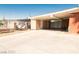 Large open carport with attached storage, a spacious driveway, and a secure metal fence at 624 N Bruce St, Las Vegas, NV 89101