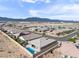 Beautiful aerial view of a residential neighborhood featuring single-story homes, pools and mountain views in the background at 6421 Winecup St, Las Vegas, NV 89149