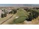 Scenic aerial view of a golf course surrounded by a residential community and mountain views in the background at 6421 Winecup St, Las Vegas, NV 89149
