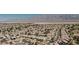 Panoramic aerial view showcasing a vast residential neighborhood with tile roofs and desert landscape with mountain views in the background at 6421 Winecup St, Las Vegas, NV 89149
