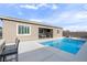 Relaxing backyard with a sparkling pool, outdoor seating, and built-in grill, perfect for outdoor entertaining and enjoying the sunshine at 6421 Winecup St, Las Vegas, NV 89149