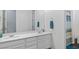 Bright bathroom features a dual sink vanity, with a large mirror and a shower in the background at 6421 Winecup St, Las Vegas, NV 89149
