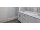 Stylish bathroom showcases double sinks with white cabinets and a marble shower, creating a clean, elegant look at 6421 Winecup St, Las Vegas, NV 89149