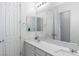 Elegant bathroom features a dual sink vanity, with large mirror and white cabinets at 6421 Winecup St, Las Vegas, NV 89149
