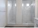 Elegant bathroom showcasing dual glass enclosed showers with white marble tiling at 6421 Winecup St, Las Vegas, NV 89149