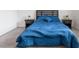 Comfortable bedroom featuring a cozy blue comforter, matching bedside tables, and soft carpeting for a peaceful retreat at 6421 Winecup St, Las Vegas, NV 89149