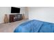 Spacious bedroom with a large TV, decorative vases, a comfortable bed, and soft carpeting for a cozy atmosphere at 6421 Winecup St, Las Vegas, NV 89149