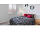 Comfortable bedroom with a bed and gray duvet, enhanced by natural light and wall decor at 6421 Winecup St, Las Vegas, NV 89149