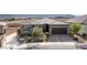 Charming single-story home featuring desert landscaping, a paver driveway and walkway, and a two car garage at 6421 Winecup St, Las Vegas, NV 89149