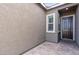 Covered front porch with paver flooring, a dark front door, and a side window providing ample natural light at 6421 Winecup St, Las Vegas, NV 89149