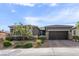 Charming single-story home featuring desert landscaping, a paver driveway and walkway, and a two car garage at 6421 Winecup St, Las Vegas, NV 89149