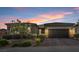 Charming single-story home featuring desert landscaping, a paver driveway and walkway, and a two car garage at 6421 Winecup St, Las Vegas, NV 89149