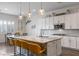 Bright kitchen featuring pendant lighting, an island with seating, stainless appliances, and lots of cabinet space at 6421 Winecup St, Las Vegas, NV 89149