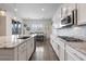 An open kitchen with granite countertops, stainless steel appliances, tile backsplash, and adjacent dining area at 6421 Winecup St, Las Vegas, NV 89149