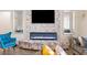 Stylish living room showcasing a modern fireplace, a mounted television, unique ottomans and comfortable seating area at 6421 Winecup St, Las Vegas, NV 89149